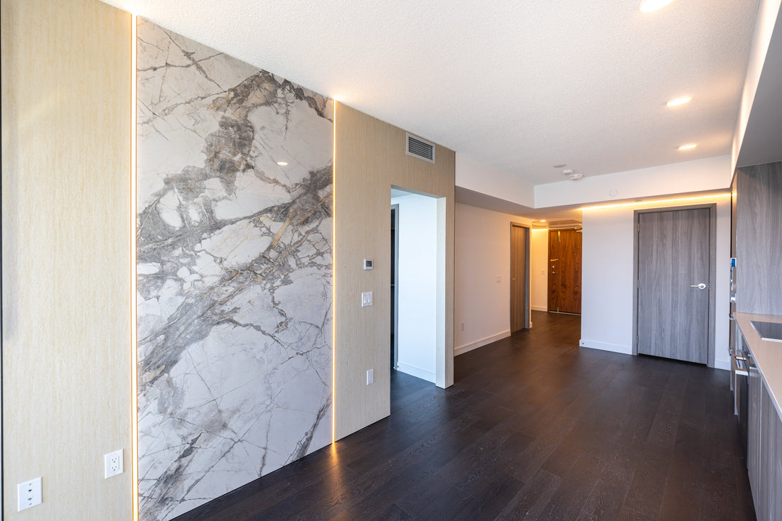 Concord Canada House West penthouse condo renovation with Travertine Beige and Weave White wall panels in the living area.
