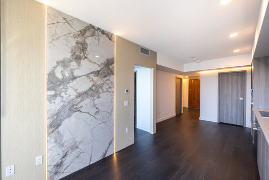 Concord Canada House West penthouse condo renovation with Travertine Beige and Weave White wall panels in the living area.