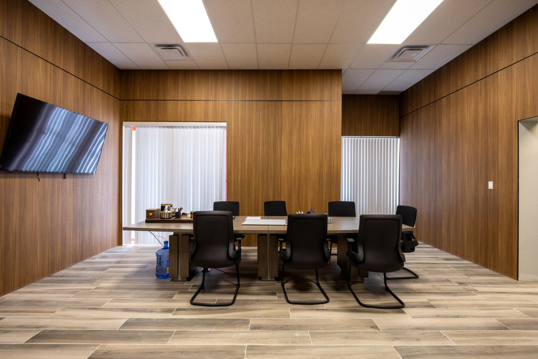 Office conference room finished with wood-look wall panels and tiled flooring