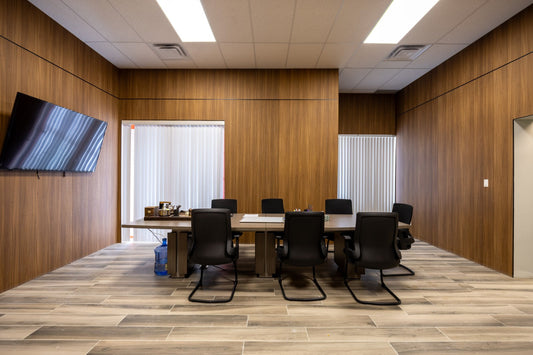 Office conference room finished with wood-look wall panels and tiled flooring
