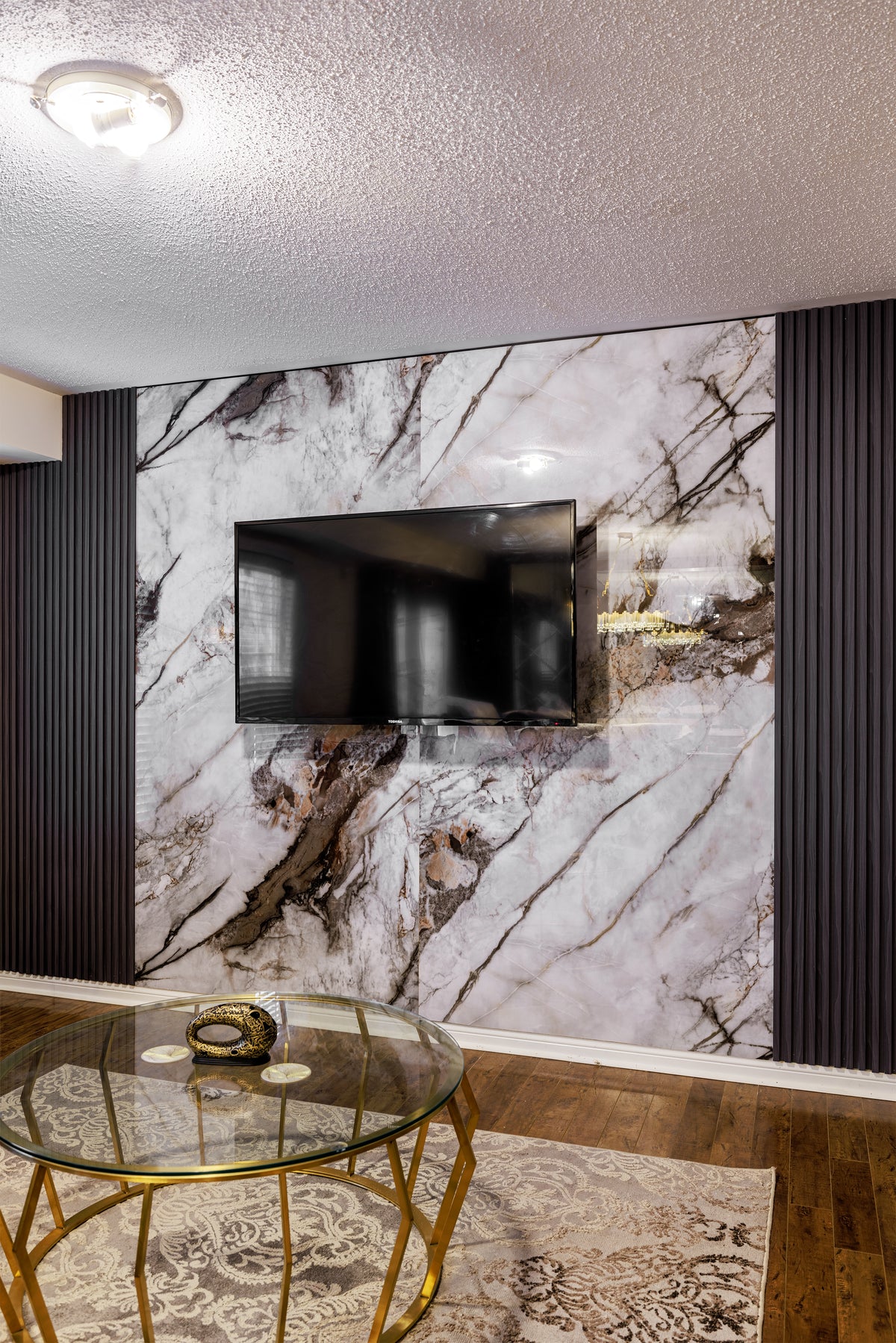 Wood black slat and marble TV wall in Scarborough by RichVaugh