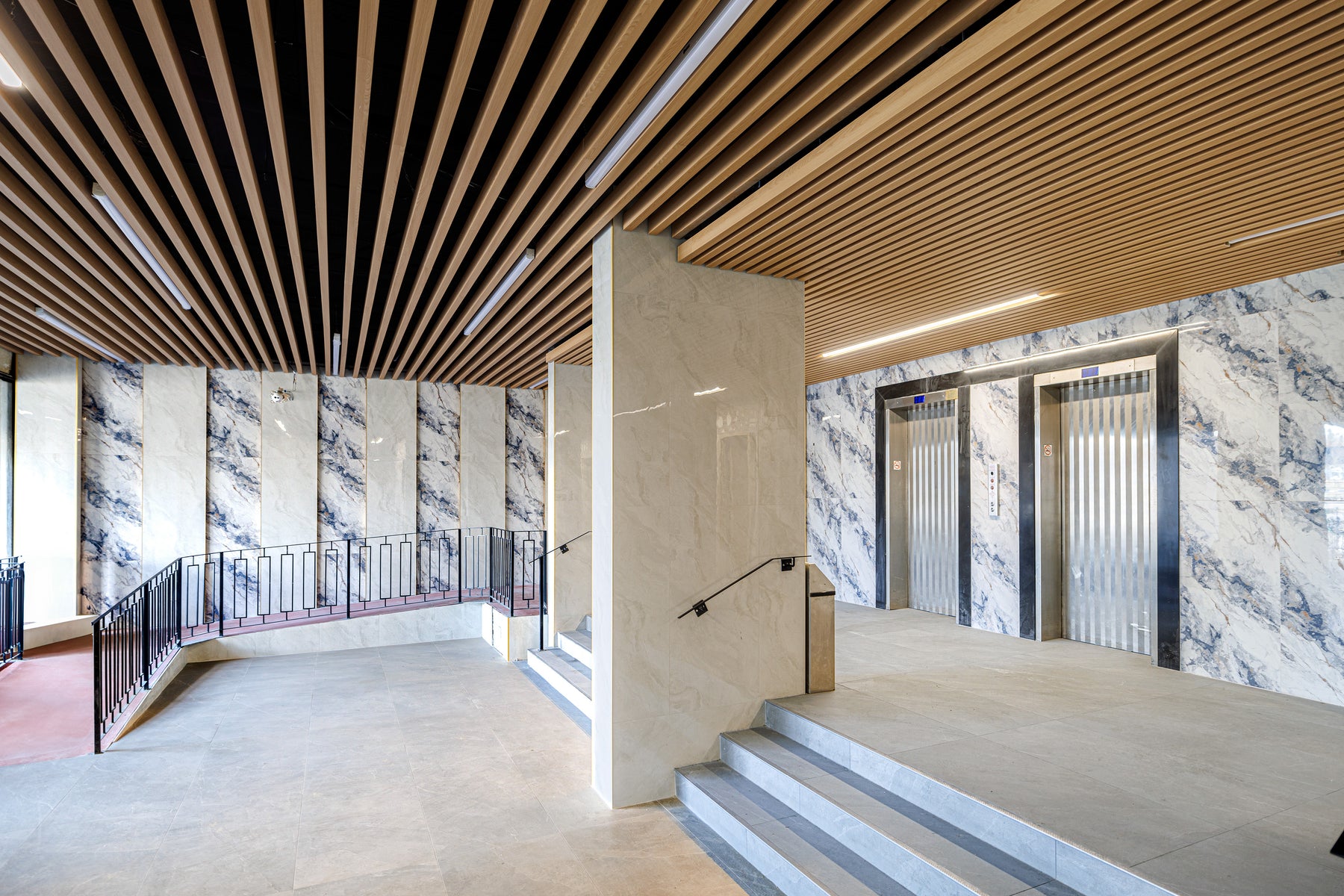 Wood ceiling panels above the elevator lobby and entrance stairs in a Scarborough condominium