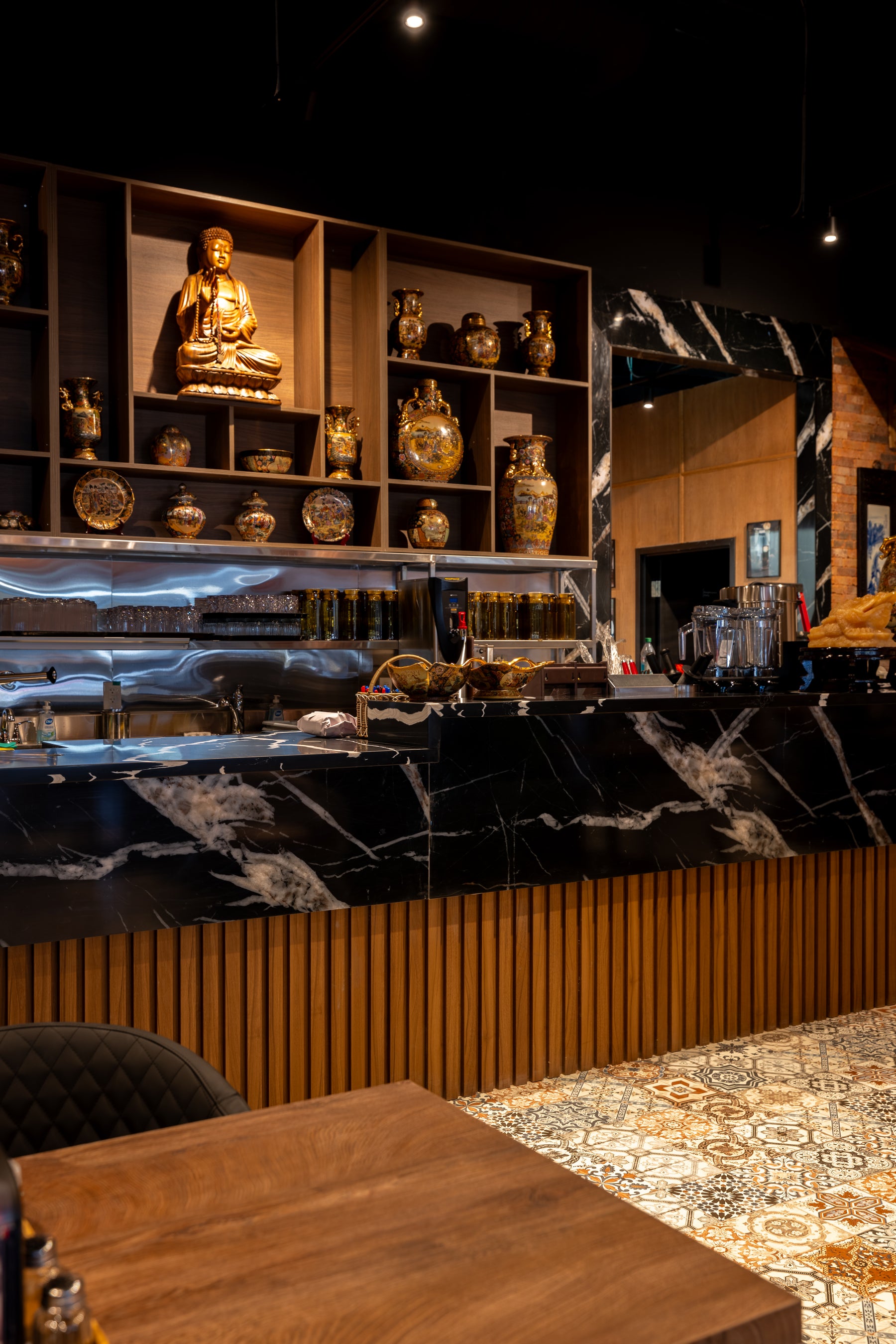 Black marble wall panel and flexible Wood Brown slat panels on a restaurant service counter in Markham Ontario