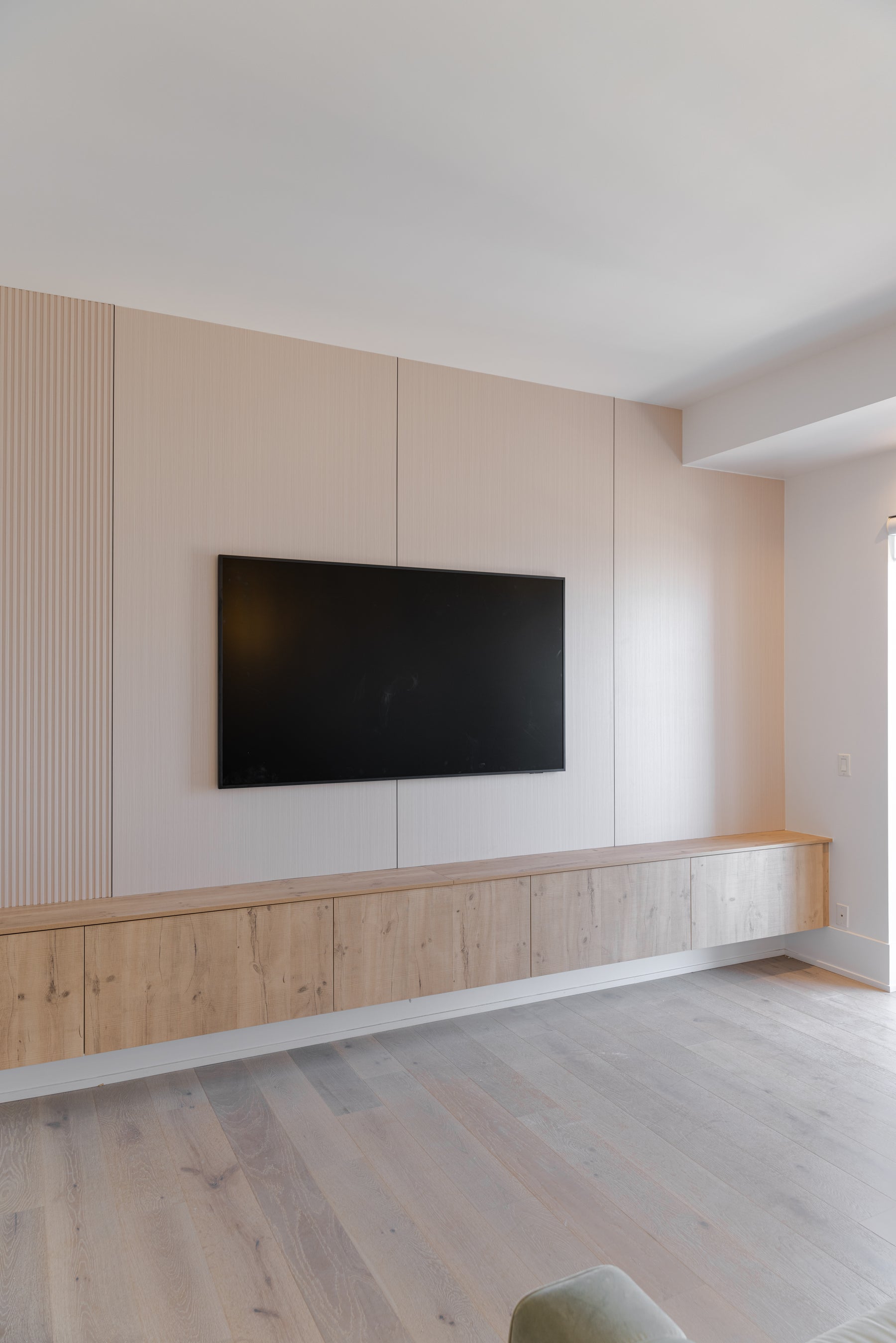 Alternate view of RichVaugh Paulownia Wood slat and large-panel TV wall in Downtown Toronto Ontario