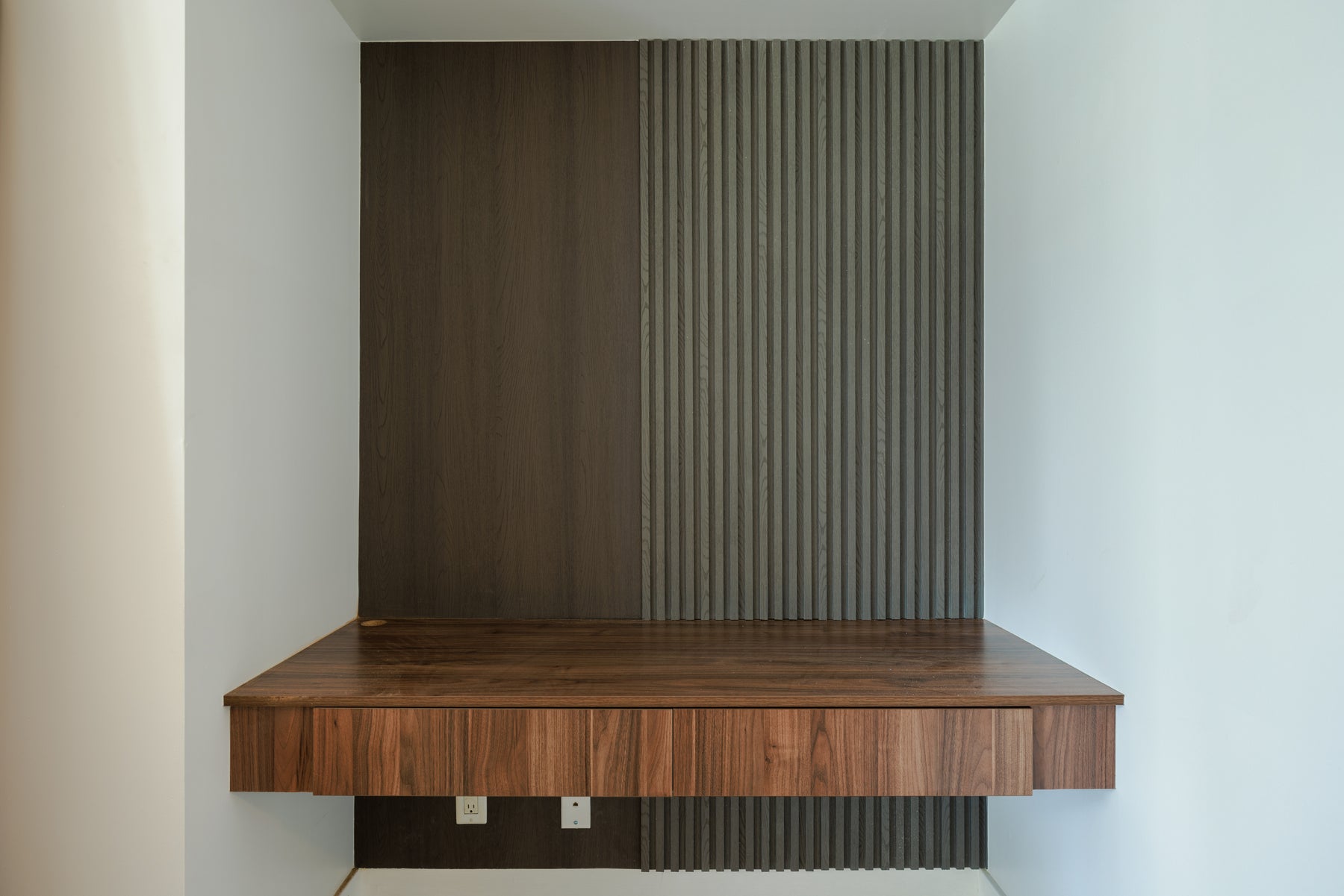 Alternate view of RichVaugh layered gray TV wall with floating wood console and concealed lighting in Downtown Toronto Ontario