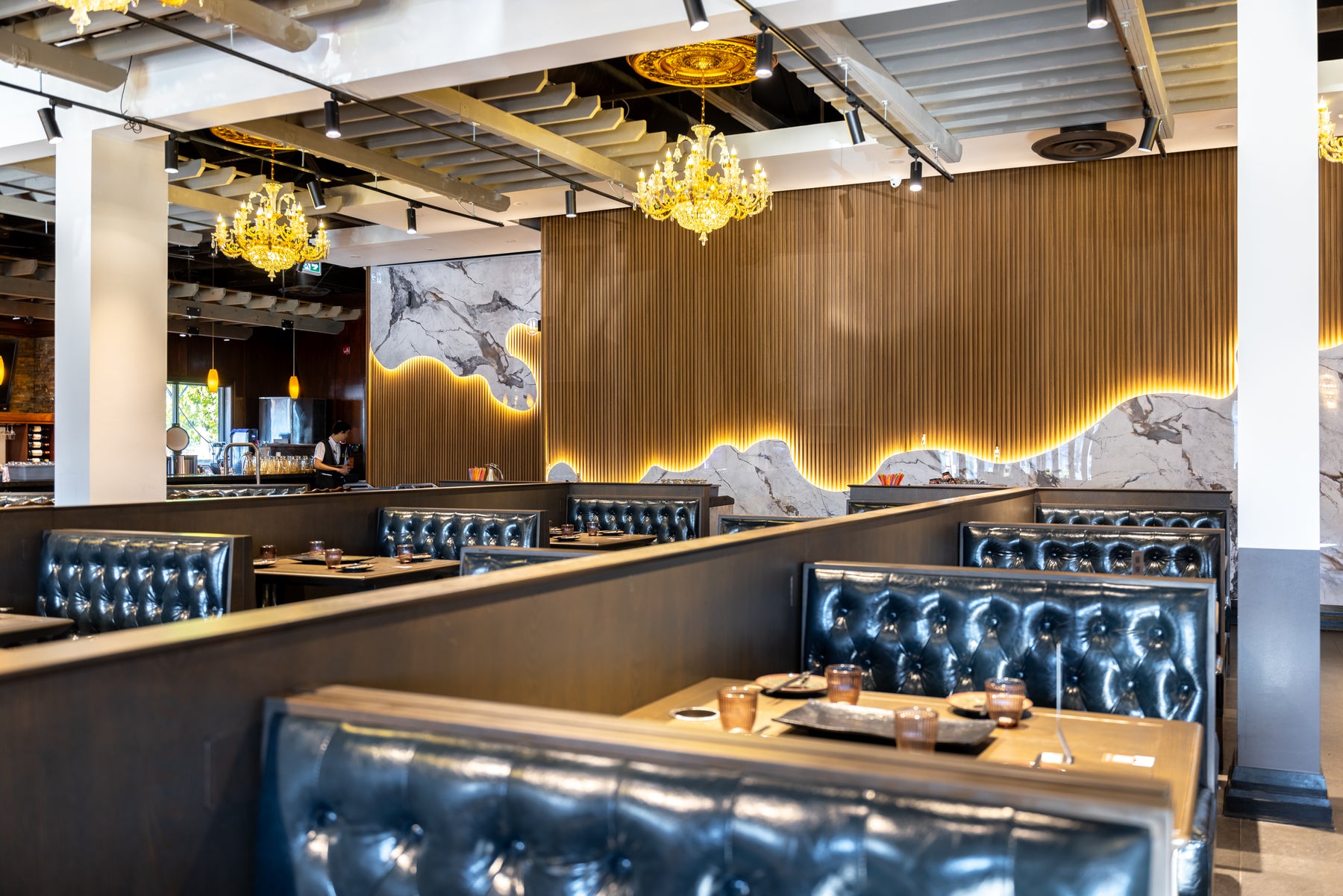 Wood Brown slat panels marble wall panels and concealed LED lighting in a Richmond Hill barbecue restaurant by RichVaugh