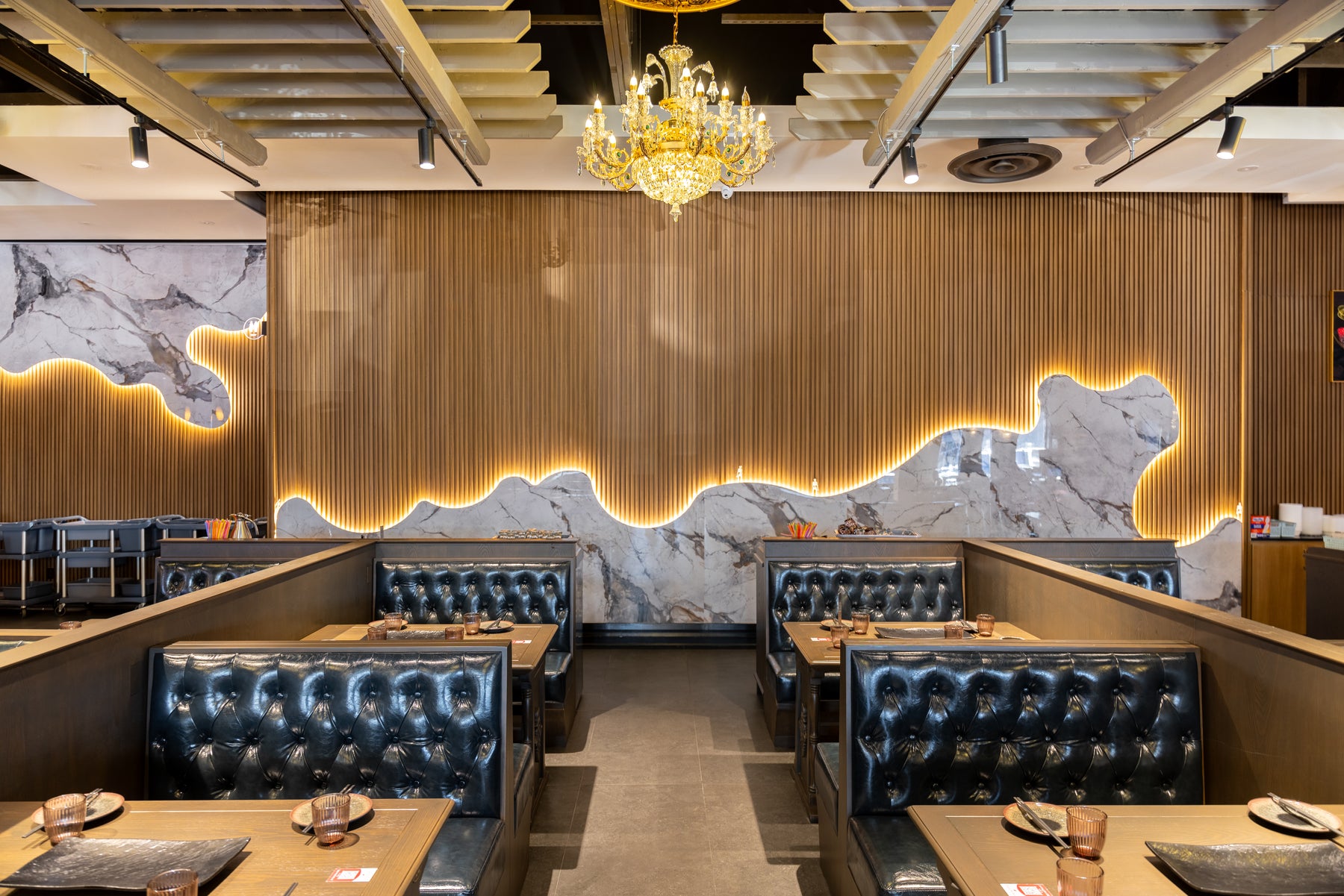 Commercial marble and Wood Brown slat feature wall behind restaurant booths in Richmond Hill Ontario