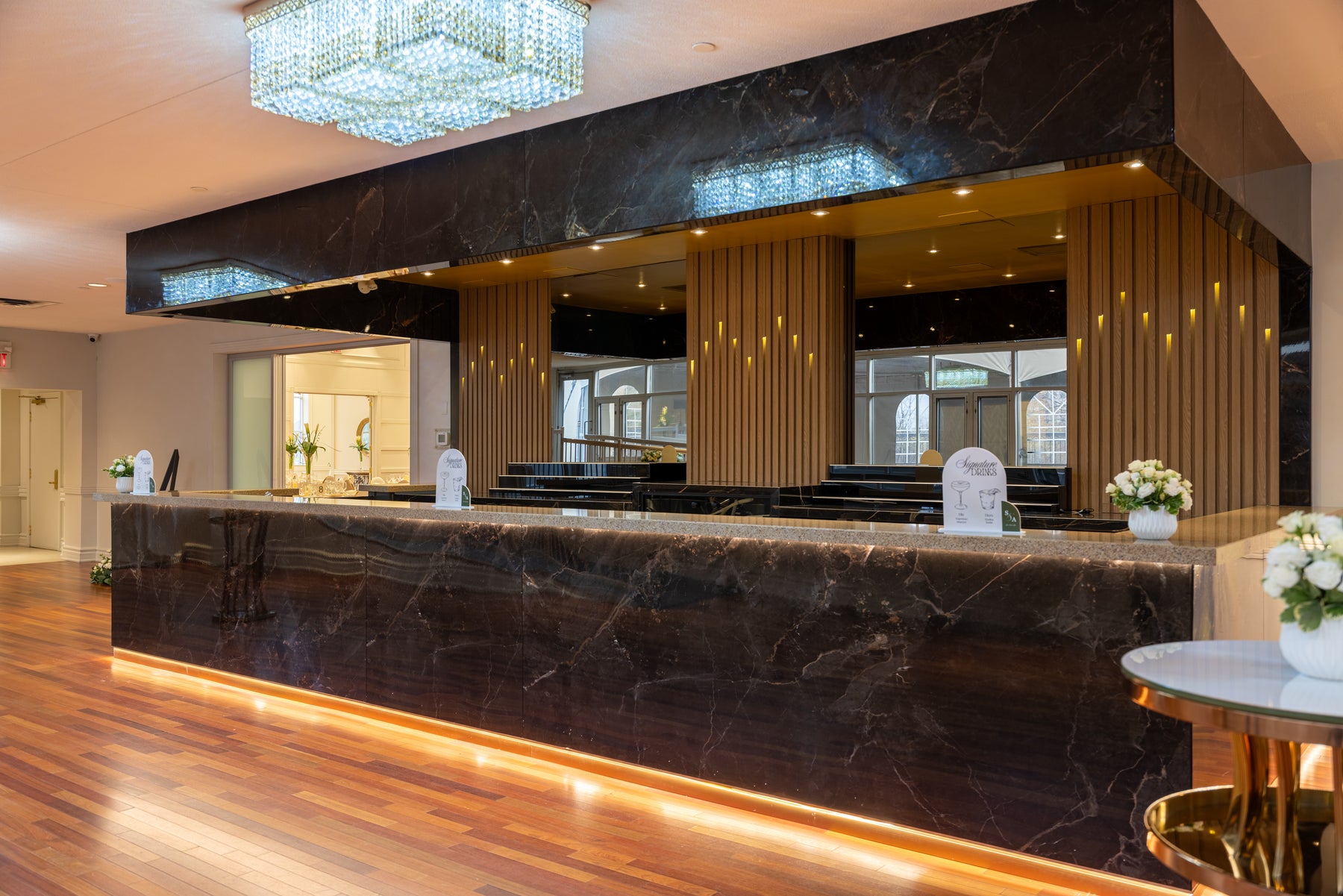Oak slat wall panels and dark marble panels installed around a wedding hall bar in Vaughan Ontario by RichVaugh