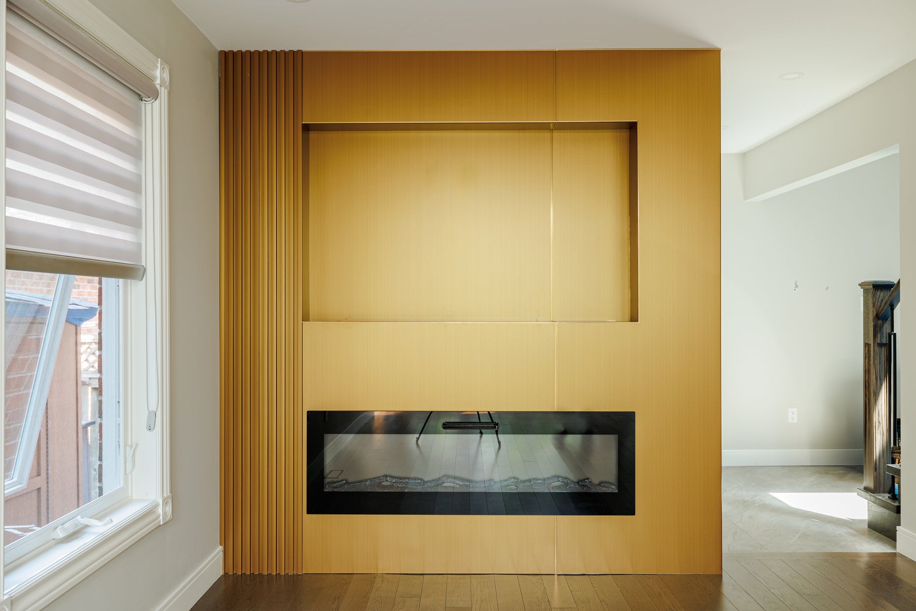 Alternate view of RichVaugh Metal Gold fireplace feature wall installation in Markham Ontario