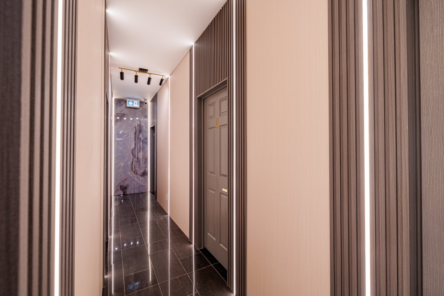 Matte Black 190 slat panels and concealed LED strips along a Markham spa corridor