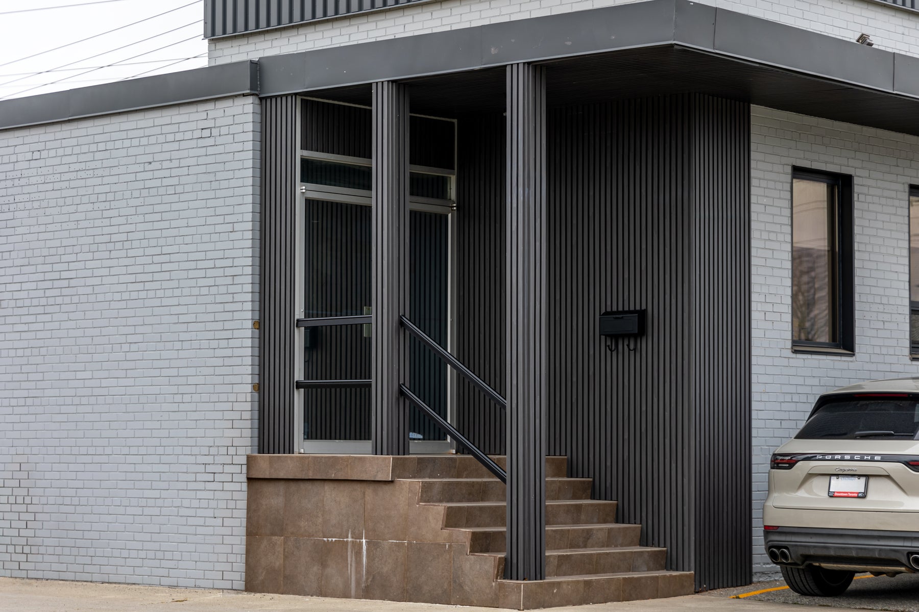 Wood Black slat panels installed around an office entrance and exterior columns in Etobicoke Ontario