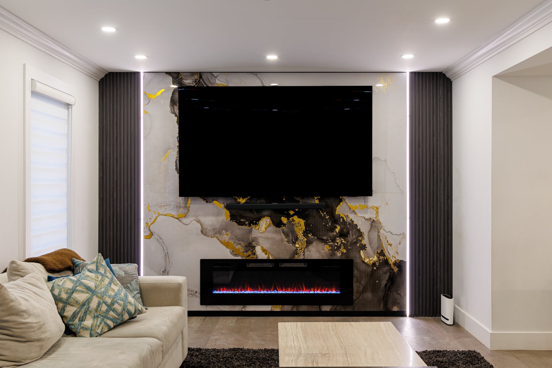 Alternate view of a completed RichVaugh Marble Wall Panel 8 and Wood Black slat fireplace TV wall in Mississauga Ontario