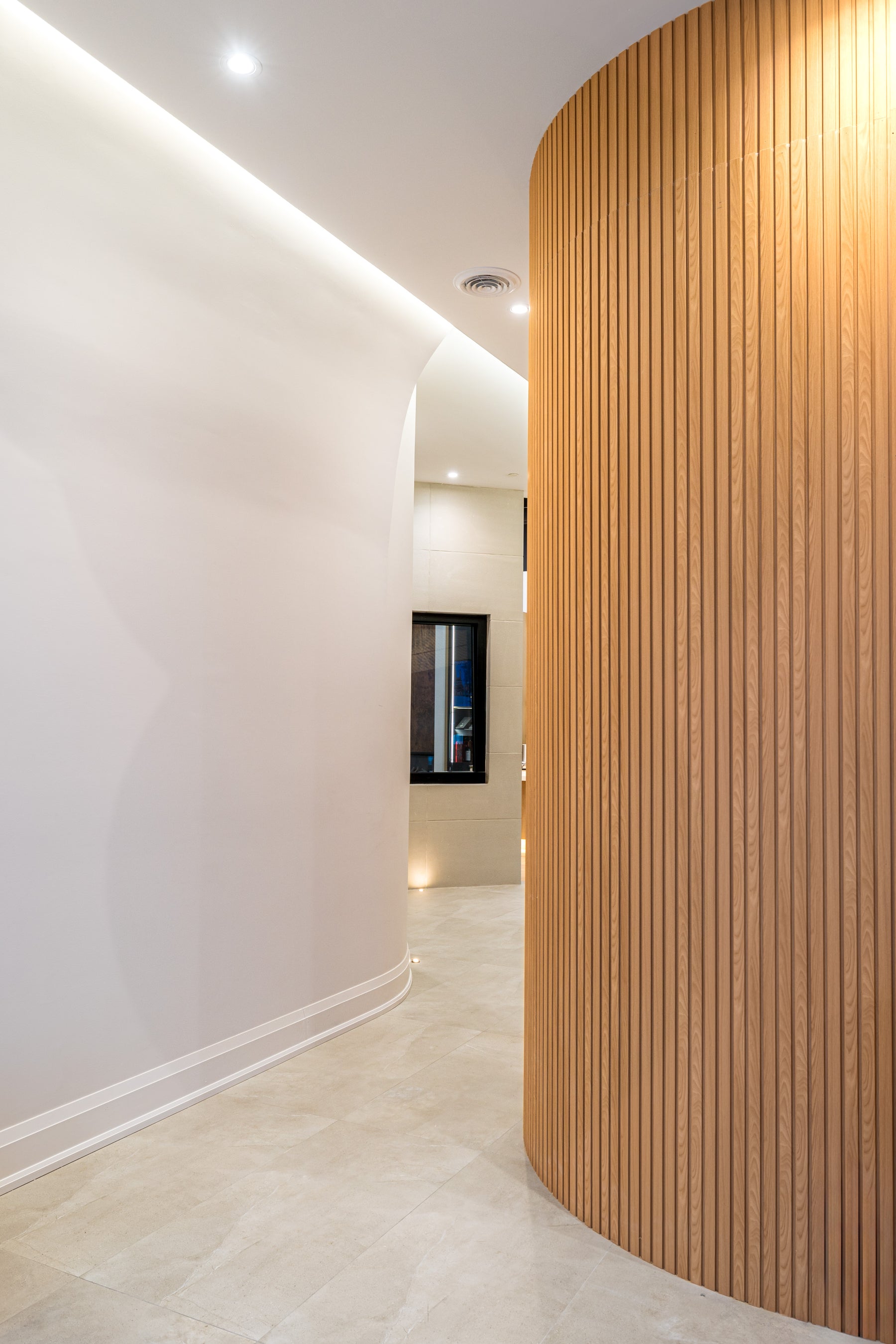 Natural Wood flexible slat wall panel detail around a rounded commercial studio wall in Richmond Hill