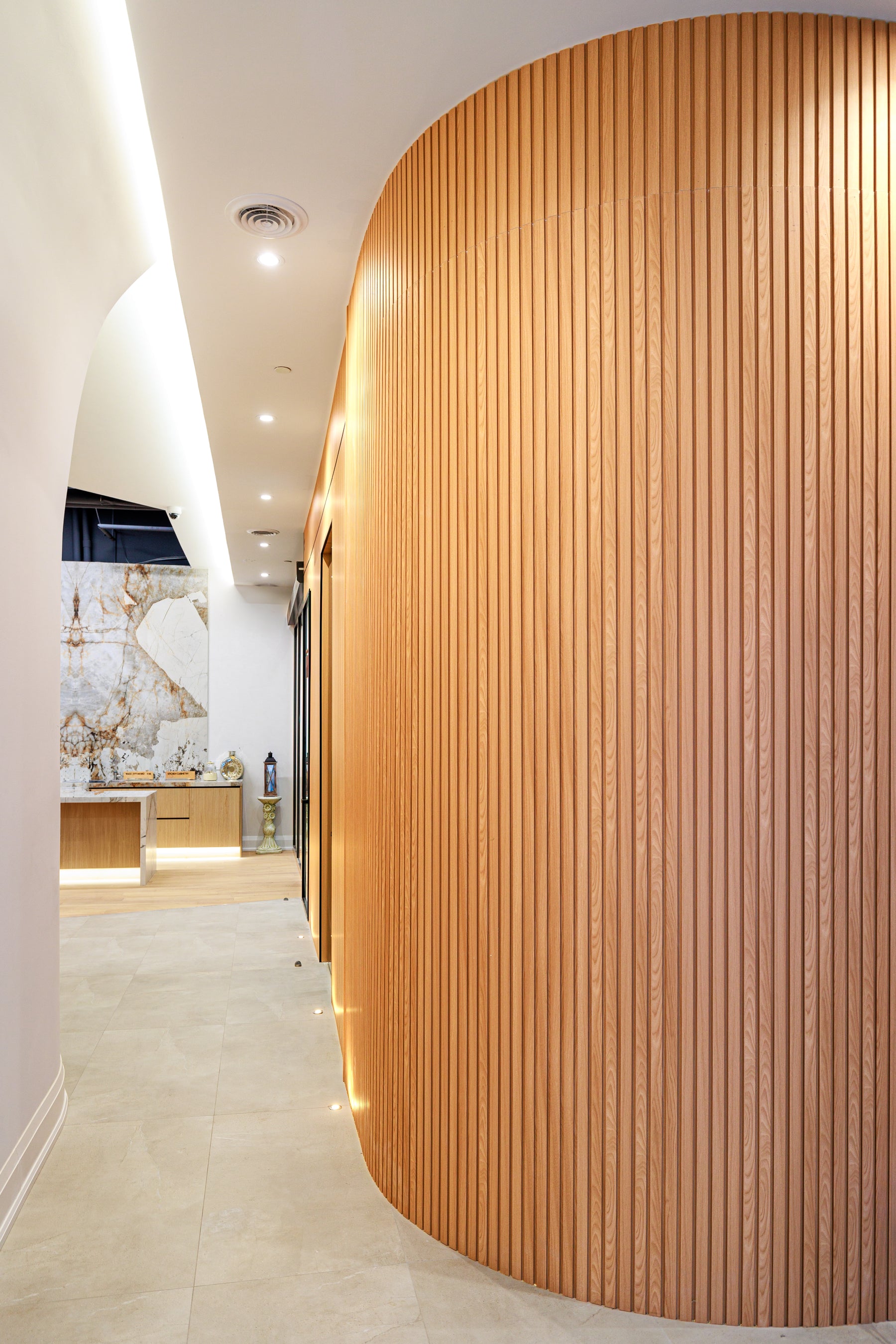 Flexible Natural Wood slat panels wrapping a curved wall in a Richmond Hill designer studio by RichVaugh