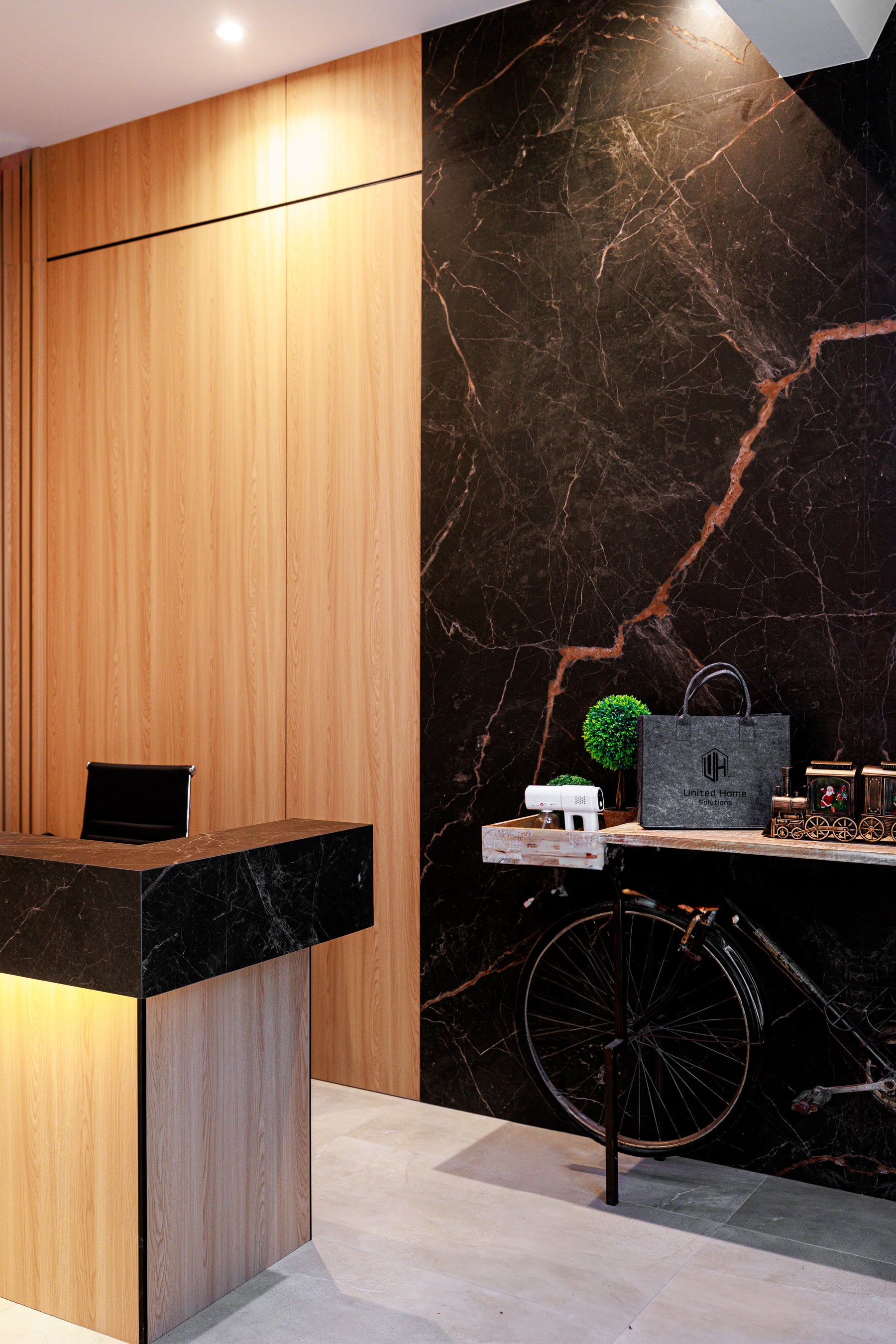 Natural Wood large wall panels and black marble reception feature in a Richmond Hill design studio
