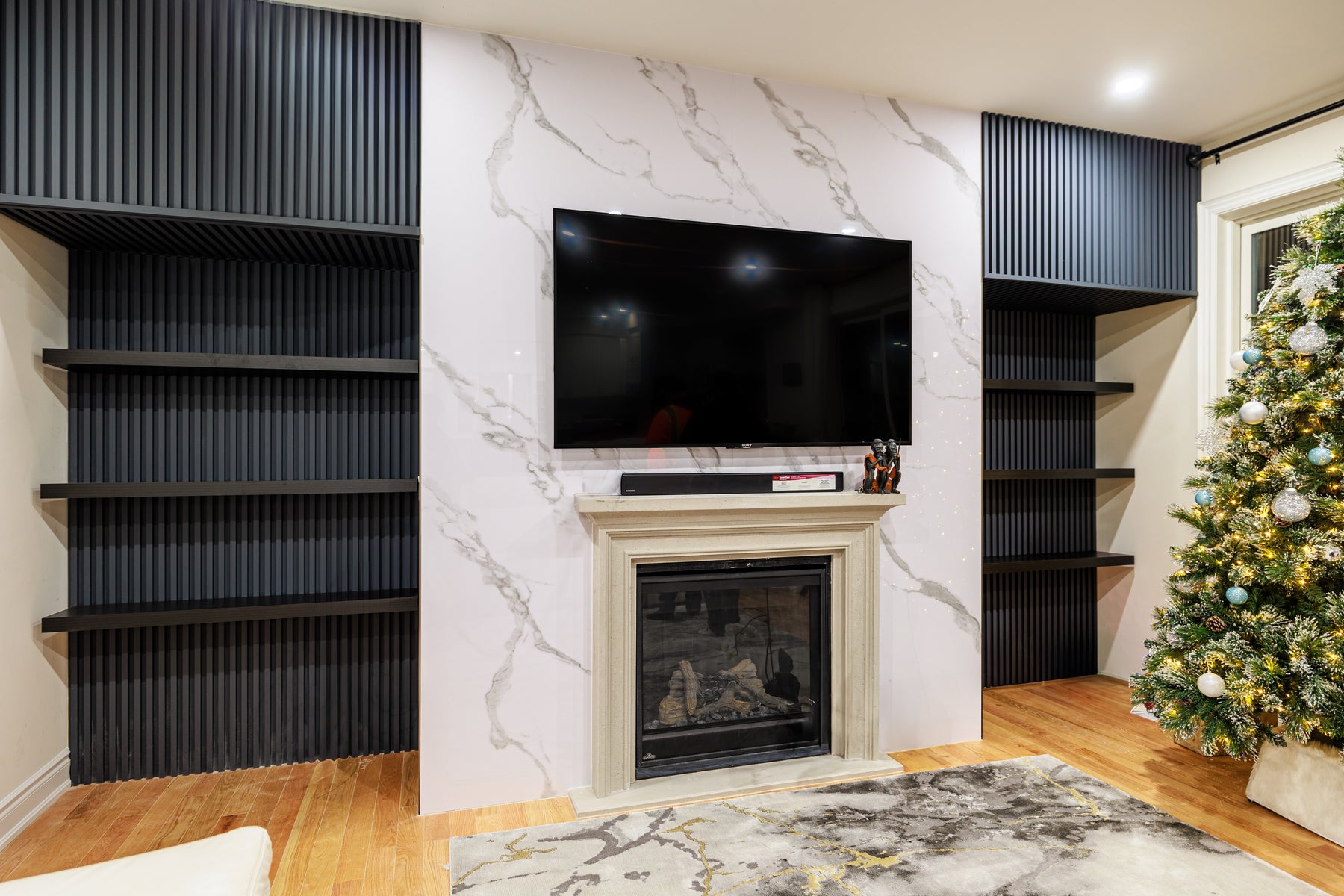 Alternate view of a completed RichVaugh Matte Gray slat and Marble Wall Panel 7 fireplace wall in Stouffville Ontario