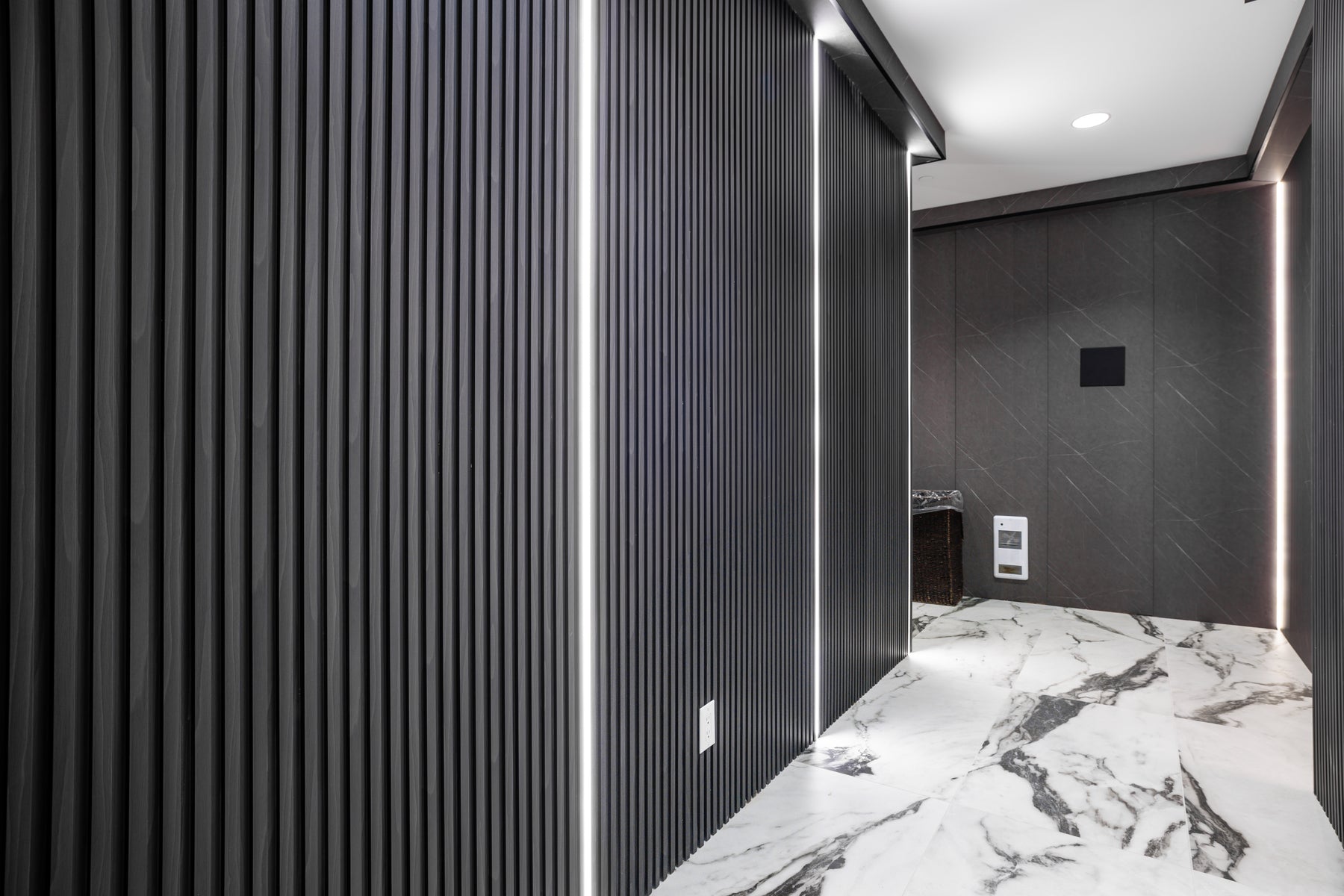 Dark Gray and Wood Black slat wall panel detail in a hotel washroom corridor in Vaughan Ontario