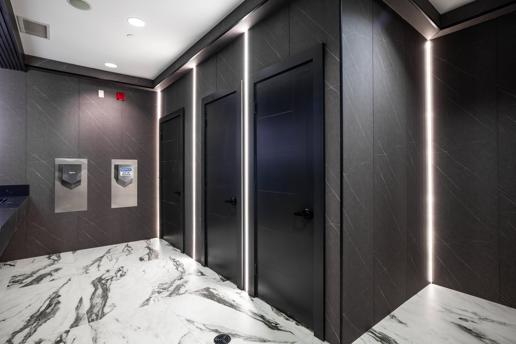 Stone Gray 1 and Stone Gray 2 small wall panels with vertical LED strips in a Vaughan hotel washroom