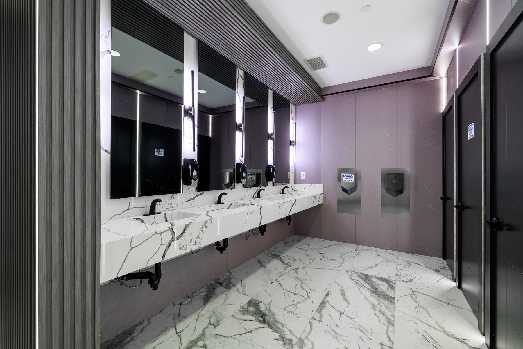 Stone Gray small wall panels and dark slat wall panels in a Vaughan hotel commercial washroom