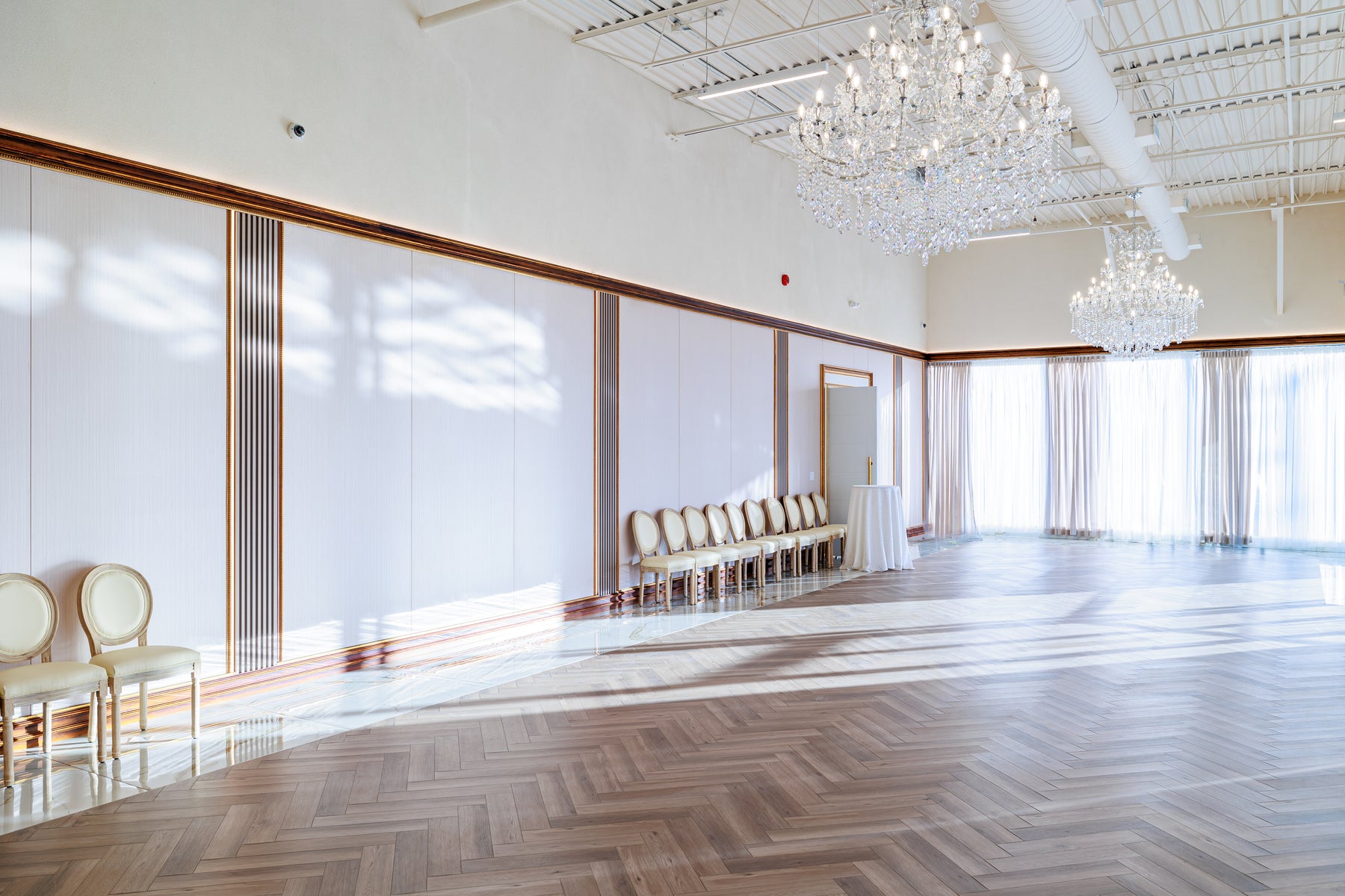 Paulownia Wood wall panels with Tech Wood slat strips beneath chandeliers in a Mississauga event venue