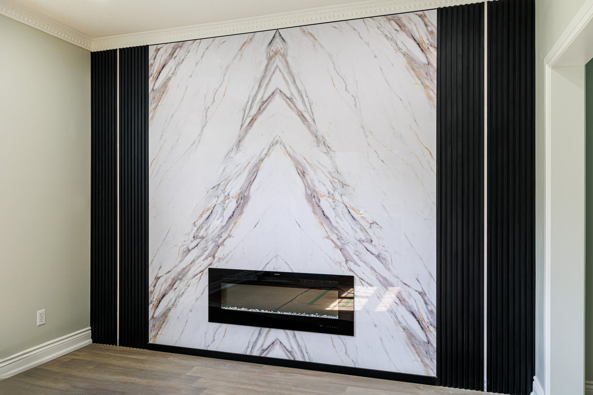 Bookmatched marble wall panel and matte black slat fireplace feature wall in Oshawa Ontario by RichVaugh