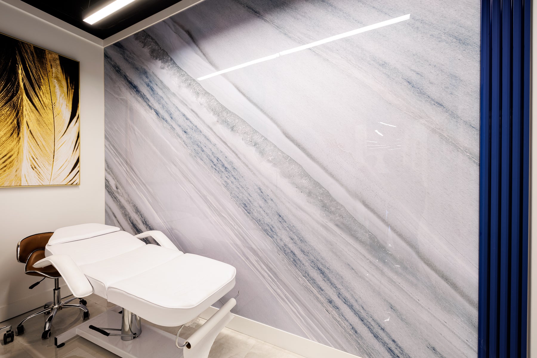 Metal Blue slat wall panel trim and blue gray feature wall in a Richmond Hill beauty salon treatment room