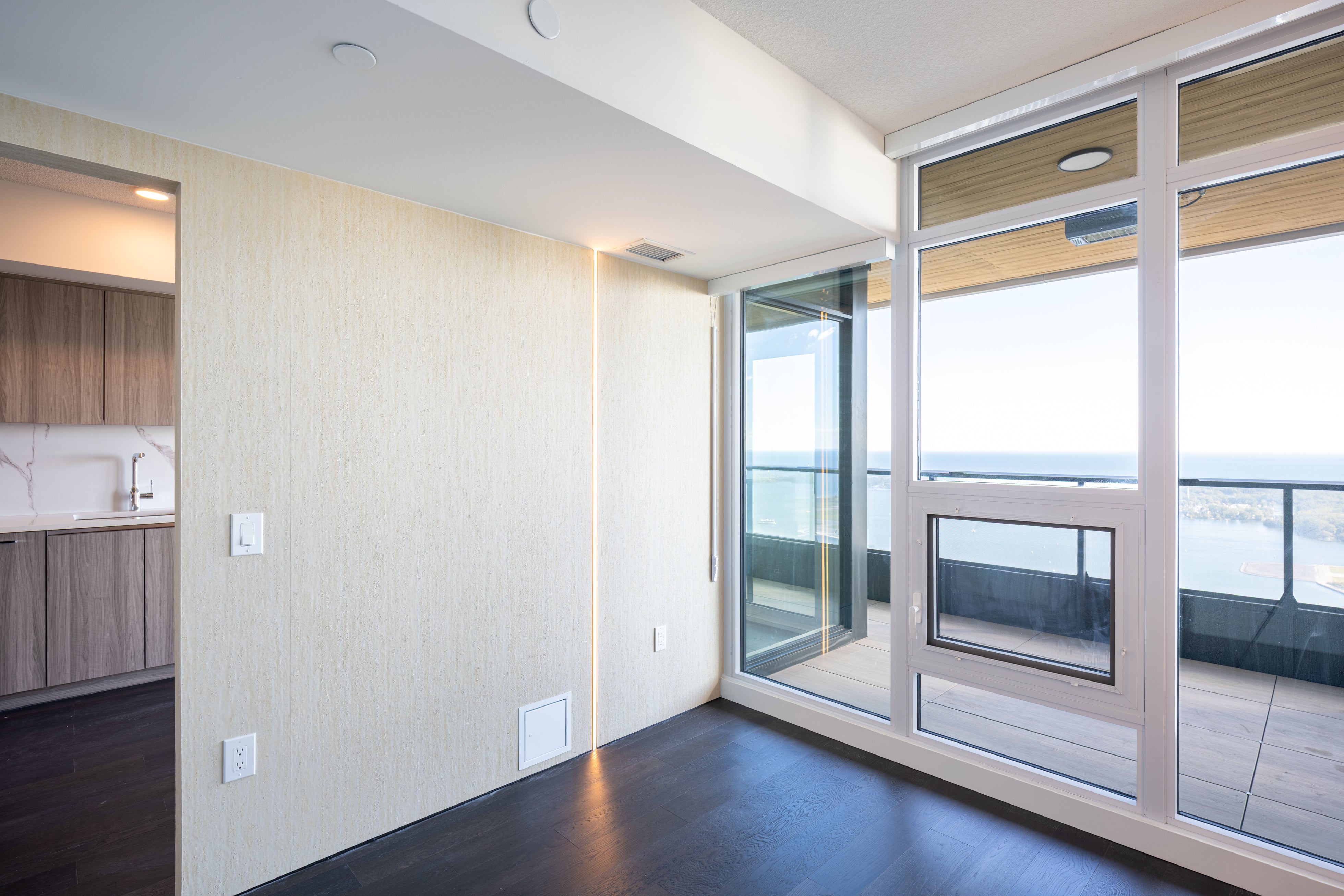 Travertine Beige wall panel installation beside the balcony in the Concord Canada House West penthouse model suite.