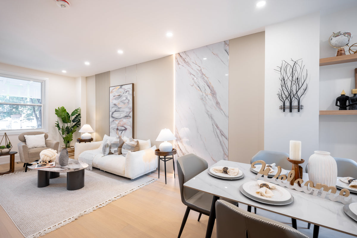 Milk White panels, slat accents and a marble-look feature panel beside a white sofa in a downtown Toronto living and dining area.