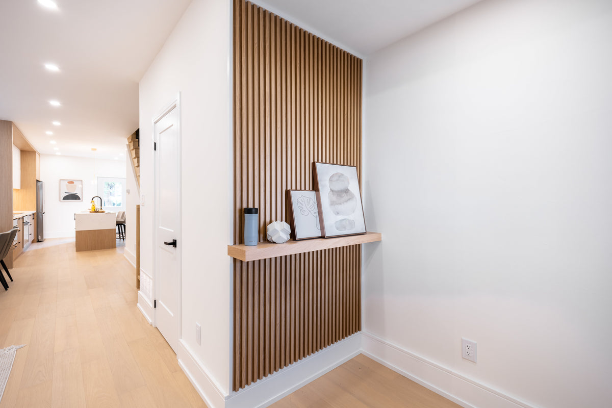 Wood-tone vertical slat accent wall with a display shelf in a downtown Toronto hallway.