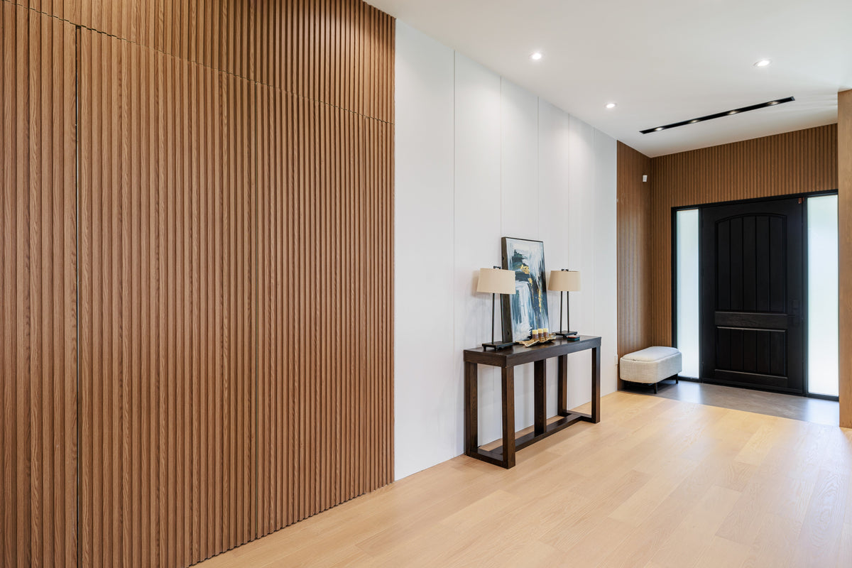 Wood-tone slat accent wall beside a console table in a Markham custom home entrance.