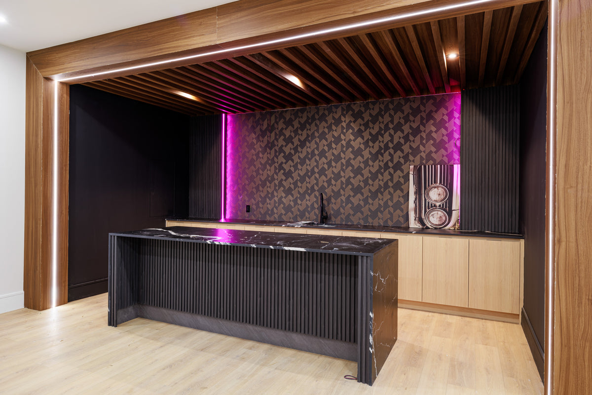 Custom home bar with dark slats, wood-tone ceiling details and purple lighting in Markham.