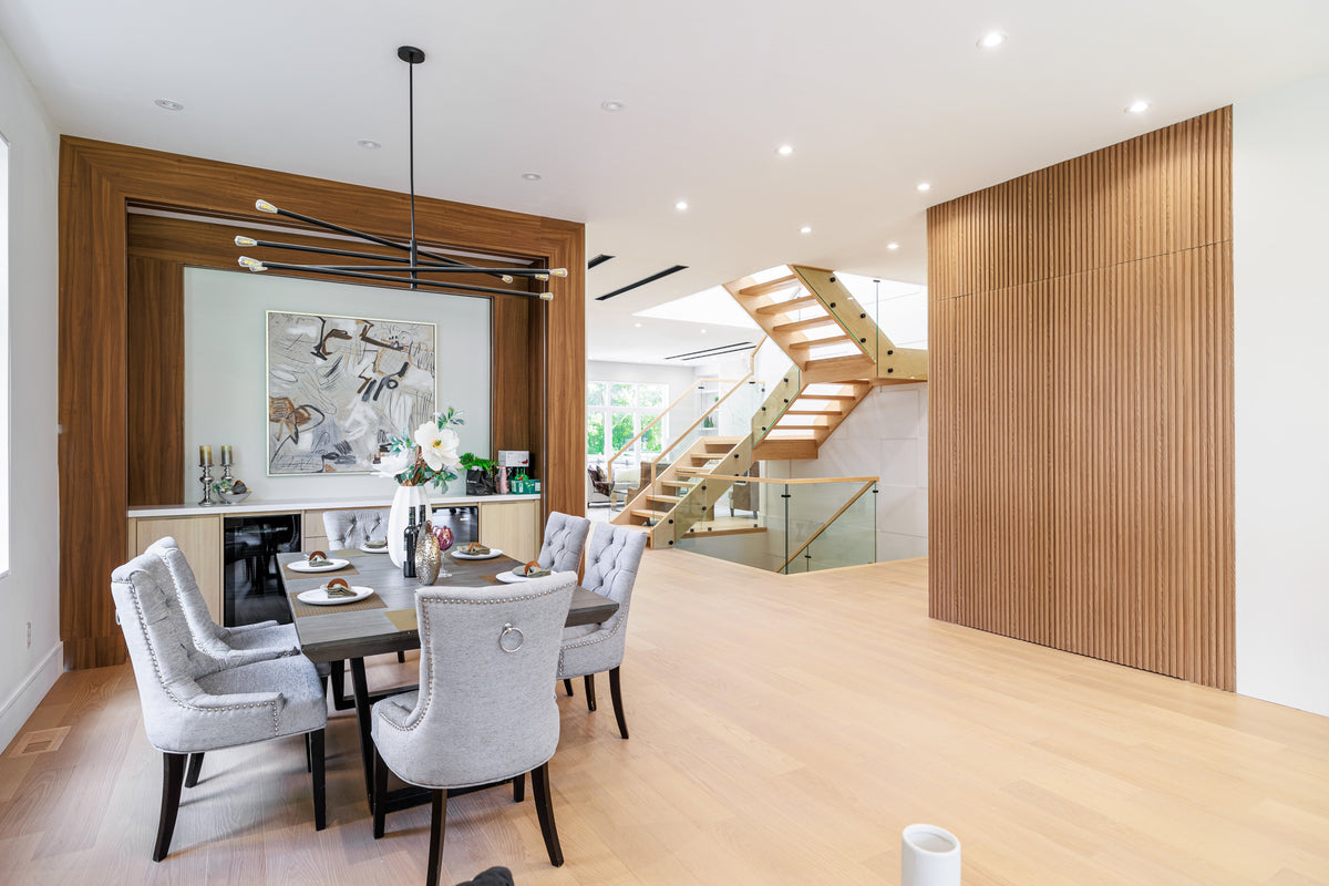 Markham dining room with a wood-tone slat accent wall beside an open staircase.