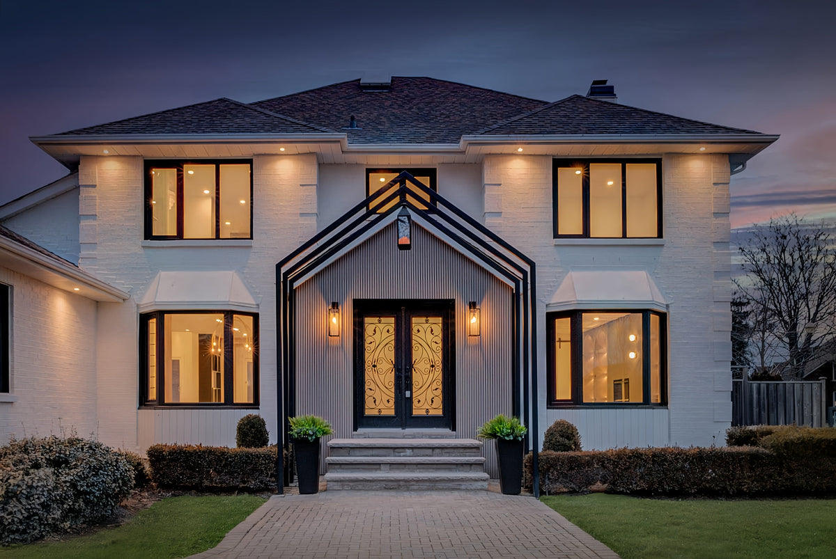 Two-storey Markham home at dusk with slat accents around the central entrance and balcony.