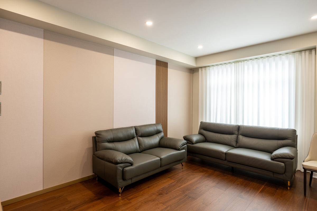 Grasscloth wall panels behind gray sofas in the living room of a whole-house project in Markham, Ontario.