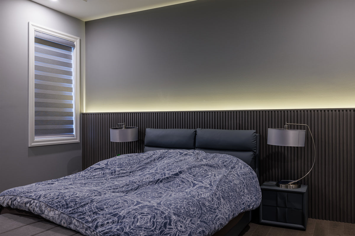 Dark gray slat headboard wall with warm linear lighting behind a bed in Markham.