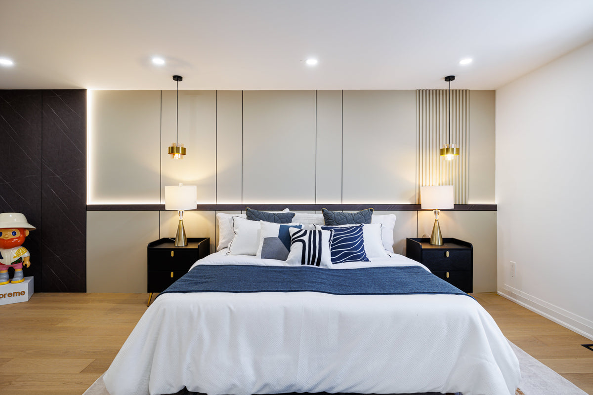 Markham bedroom with pale wall panels, vertical slat accents and pendant lights behind the bed.