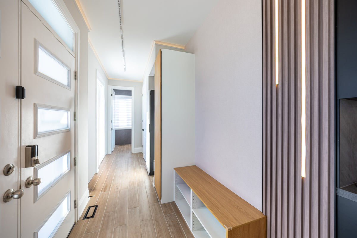 Entrance hallway with a slat accent and vertical LED lighting in a Markham whole-house project.