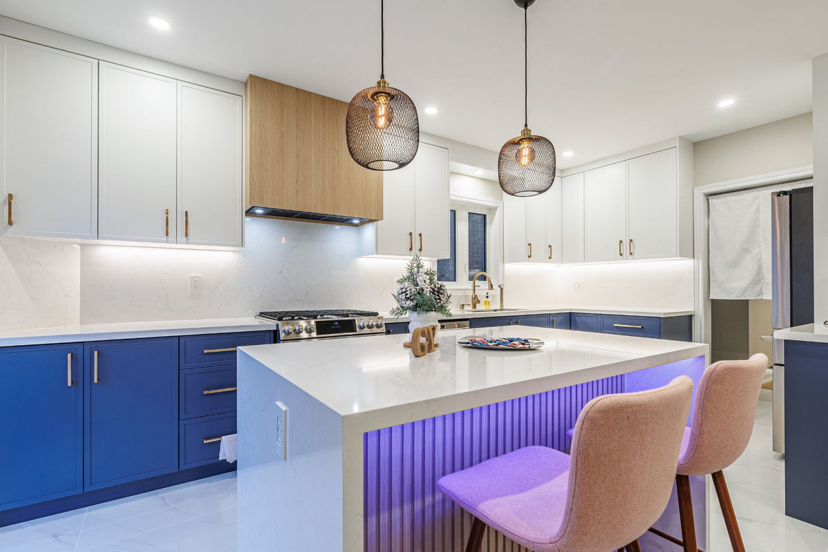Newmarket kitchen with a white island, blue lower cabinetry and wood-tone accent details.