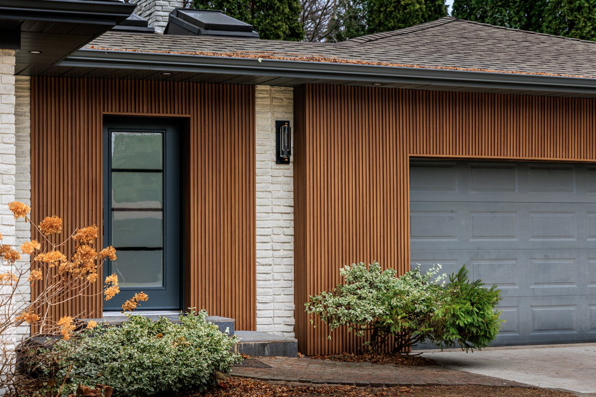 Niagara Falls garage facade with brown slat siding, dark trim and a gray garage door.