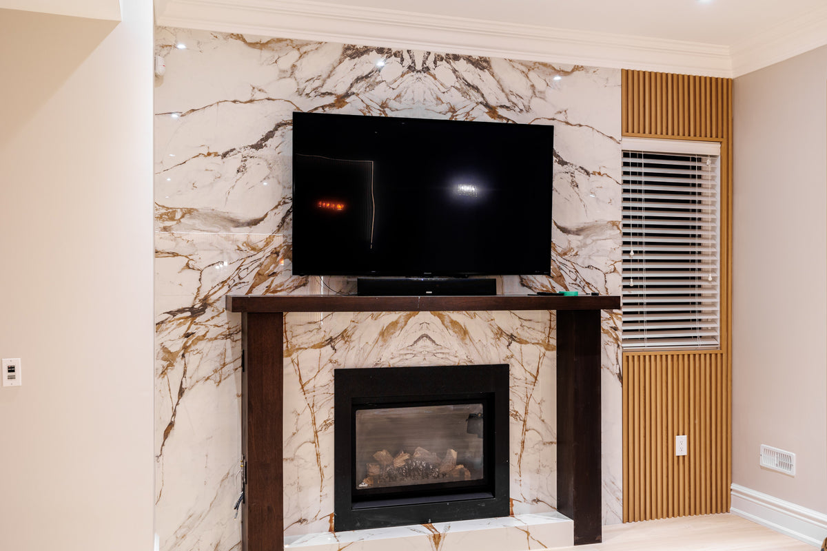North York basement TV and fireplace wall with a marble-look centre and Natural Wood slat accent.