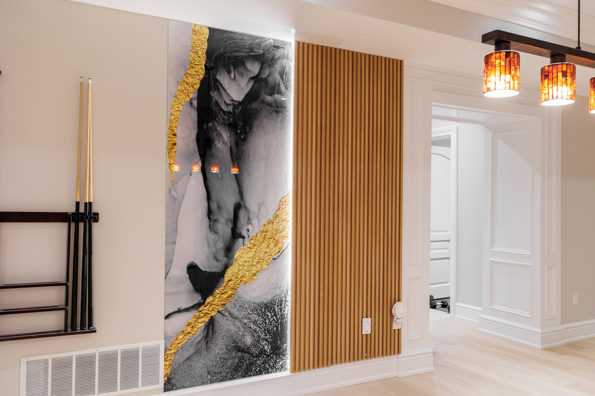 Decorative black, white and gold feature panel beside wood-tone slats in a North York basement.