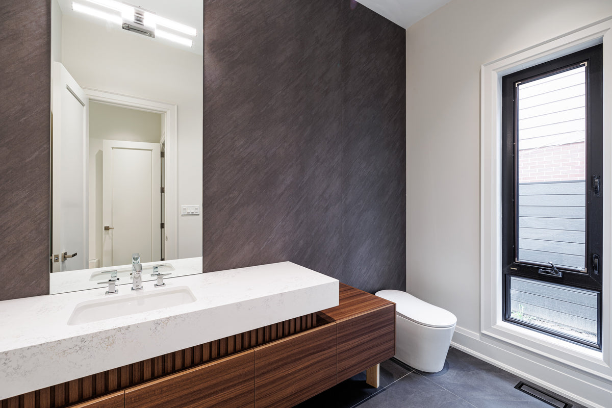 North York bathroom with a white vanity and dark textured feature panel beside the window.