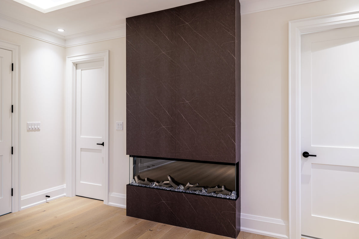 Dark fireplace feature wall between white doors in a North York custom home.