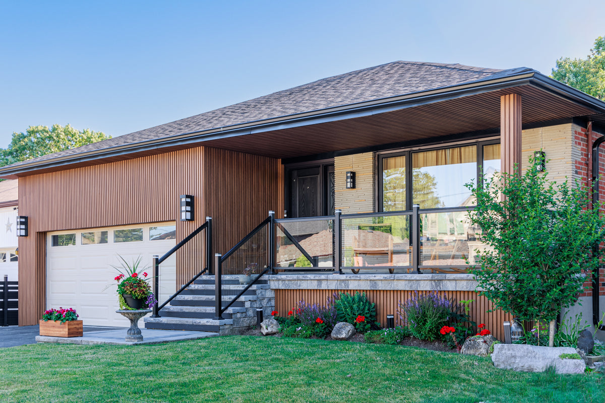 Richmond Hill bungalow with Wood Brown vertical siding, a white garage door and covered entry.