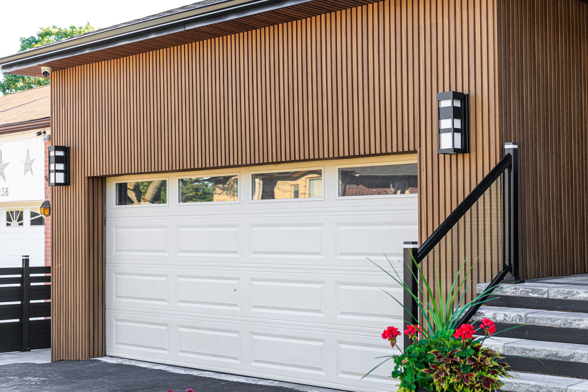 Wood Brown siding above a white garage door on a Richmond Hill home.