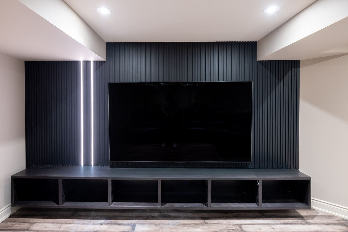 Matte black slat TV wall with vertical LED lighting and built-in media console in Whitby Ontario by RichVaugh